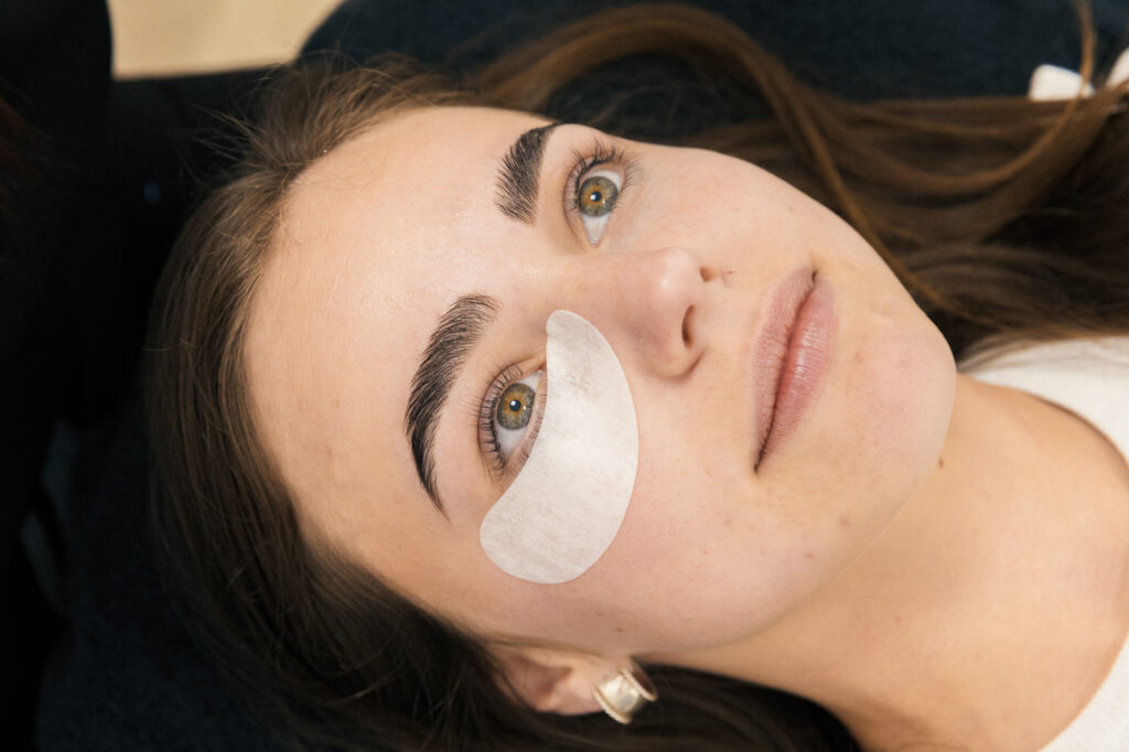  A patient has her eyes open with pads underneath as she prepares for eyelash extensions in Georgetown.