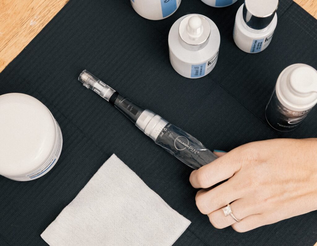 One of our expert providers reaches for the handheld device for microneedling in Georgetown, preparing to treat a patient with this advanced technology.